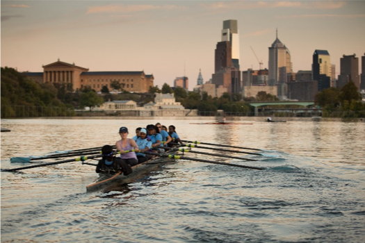 Girls rowing with skyline in background